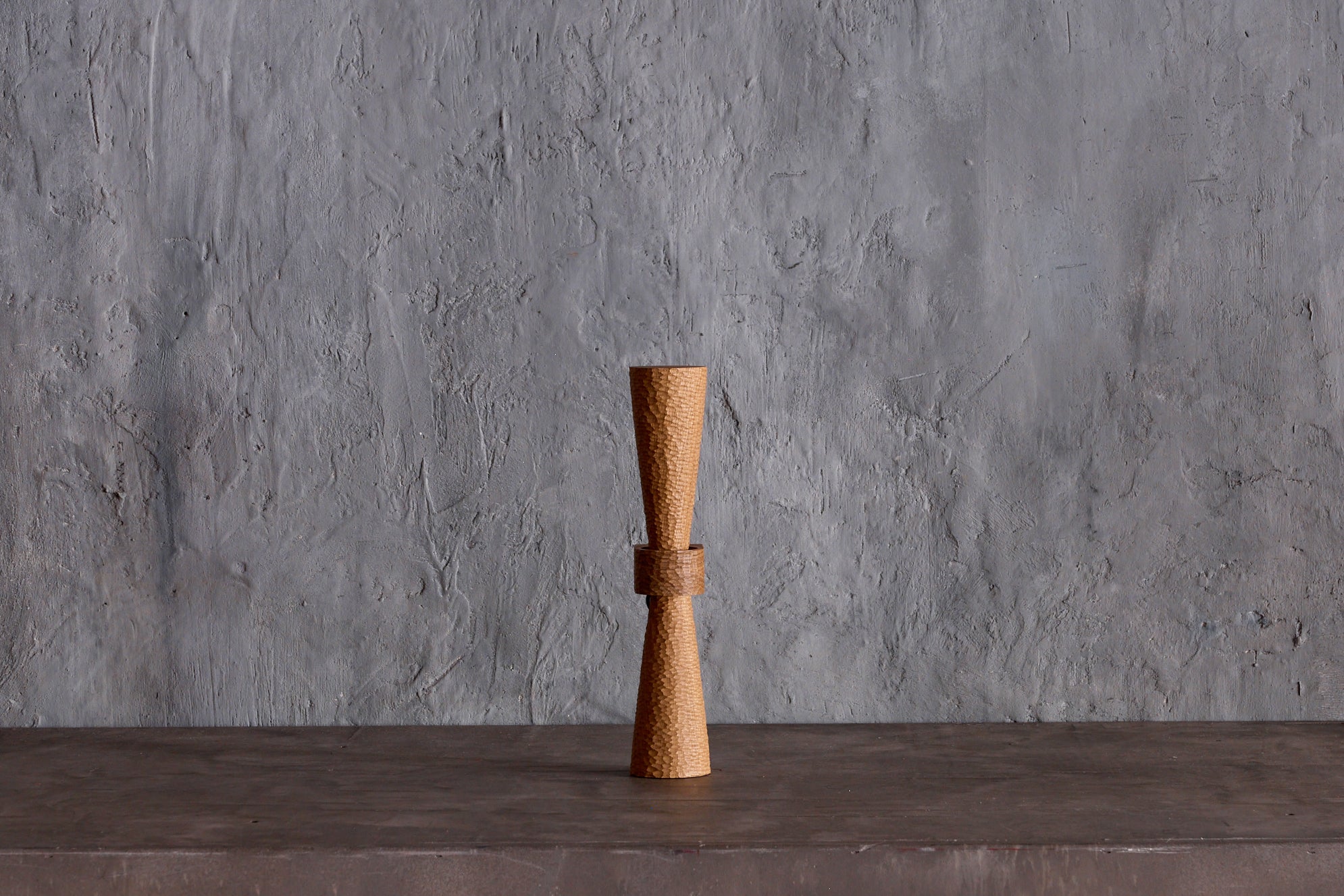 Sconce with a tiny scallop-textured and tapered upper and lower standoff allowing the texture to graduate from full light at the centre to diminished light at the ends really allowing the texture to come alive. It is just as beautiful in an entirely different way when not lit giving the sconce a whole new complexion.