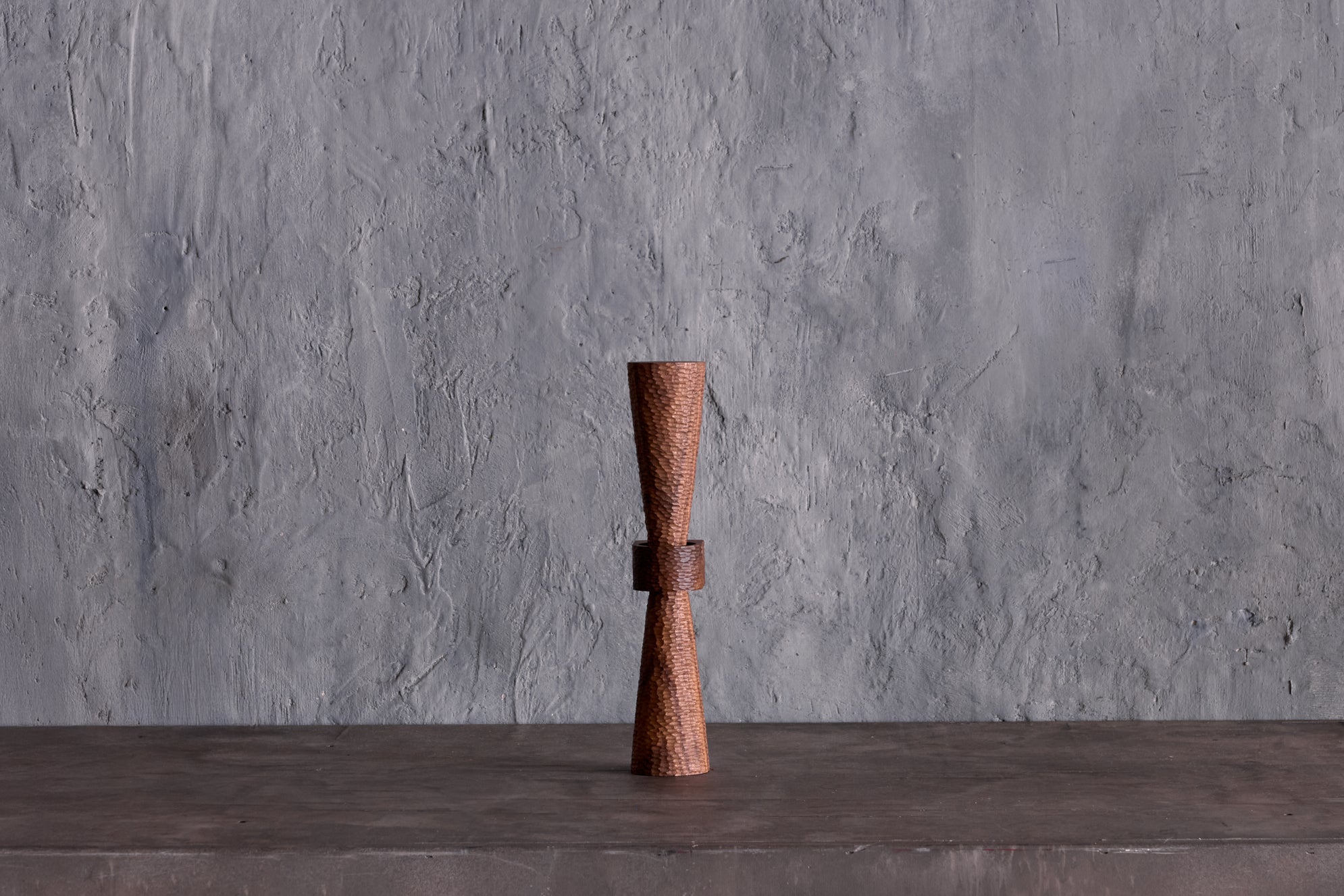 Sconce with a tiny scallop-textured and tapered upper and lower standoff allowing the texture to graduate from full light at the centre to diminished light at the ends really allowing the texture to come alive. It is just as beautiful in an entirely different way when not lit giving the sconce a whole new complexion.